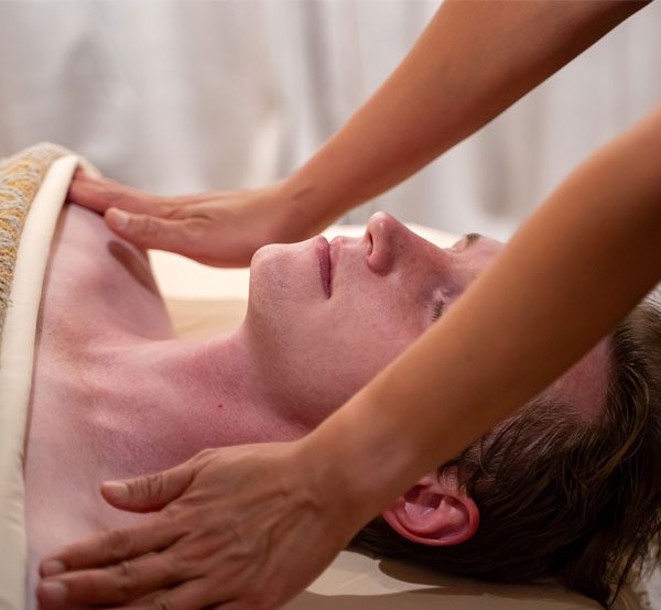 A man receiving a massage by a therapist