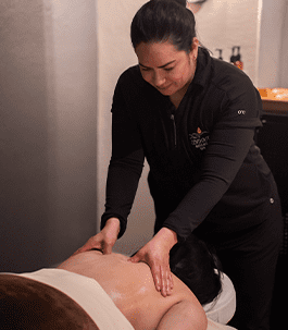 A therapist performing a deep tissue massage on a client's back