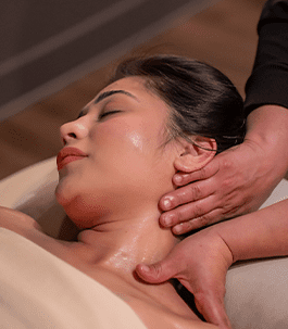 A woman relaxing while receiving a Swedish Massage.