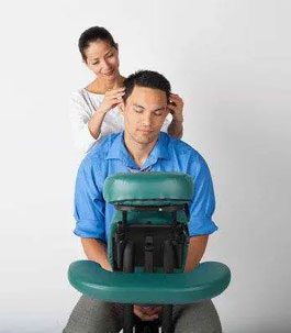 in office treat A man getting an in-office chair massage.
