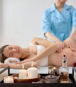parental massag A pregnant woman relaxing while getting a prenatal massage
